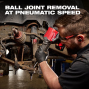 Worker using the M18 FUEL STRIKER Hammer Chisel on a vehicle suspension assembly