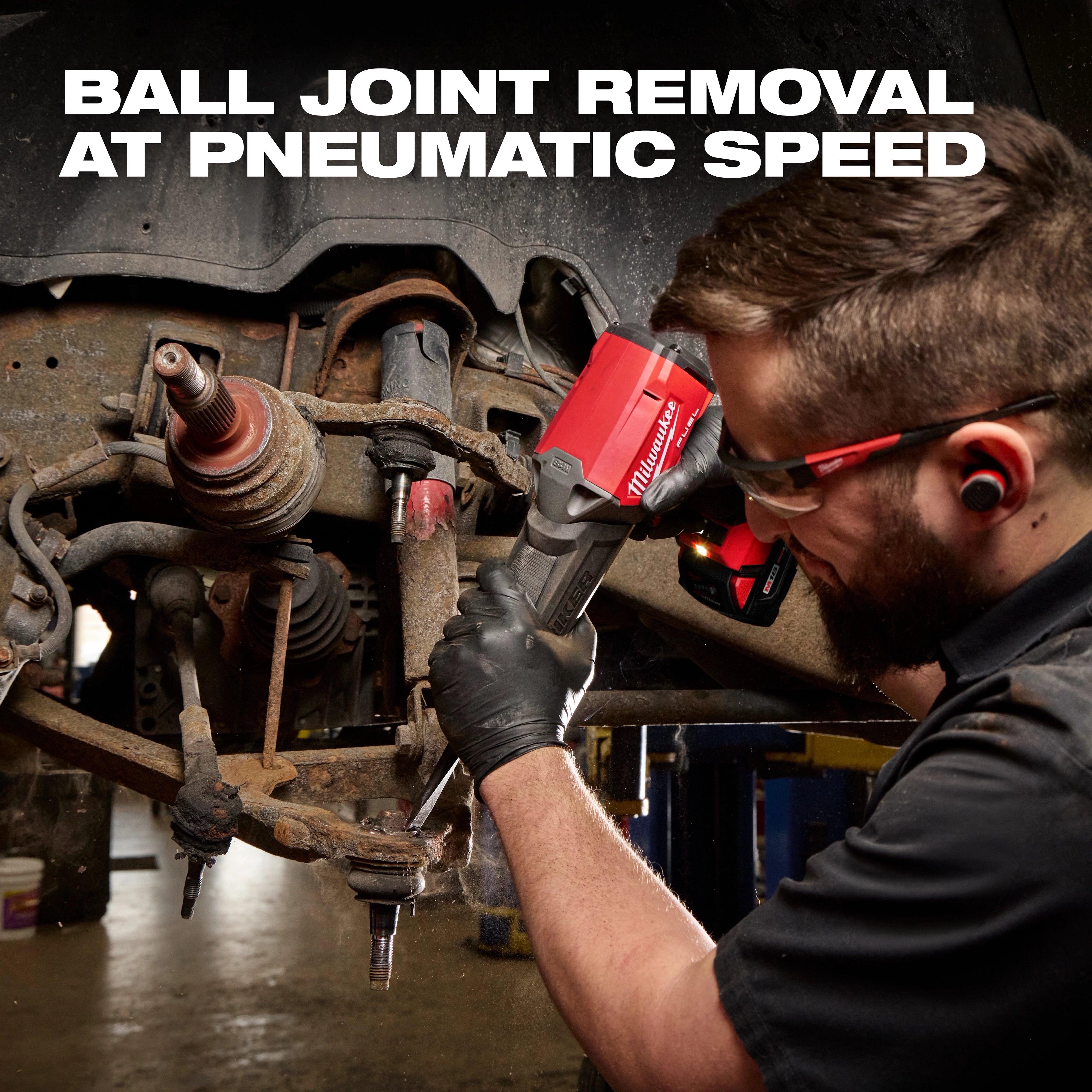 Worker using the M18 FUEL STRIKER Hammer Chisel on a vehicle suspension assembly